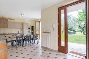 a kitchen and dining room with a table and chairs at Casa Alessandra in Torri del Benaco