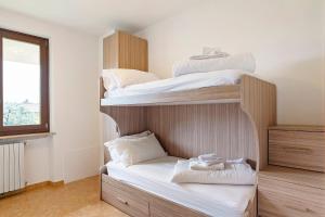 a bedroom with two bunk beds and a window at Casa Alessandra in Torri del Benaco +27 photos