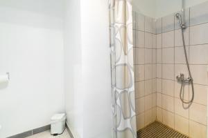 a shower with a glass door in a bathroom at La Charrette in Dunières-sur-Eyrieux +24 photos