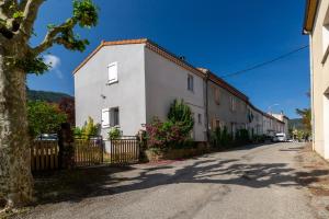 a white house on the side of a street at La Charrette in Dunières-sur-Eyrieux