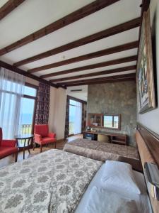 a bedroom with a king sized bed and a fireplace at Masi Otel in Bademli