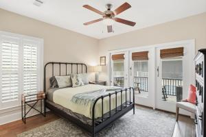 a bedroom with a bed and a ceiling fan at Garden Cottage 62 in Jekyll Island +40 photos
