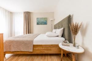 a bedroom with a large bed and a table at Palangos Vila in Palanga +126 photos