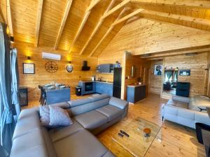 a living room with a couch and a kitchen at Holiday House Novus in Selno