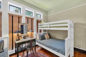 a bedroom with a bunk bed and a desk at Emil Cottage in Saint Simons Island +58 photos