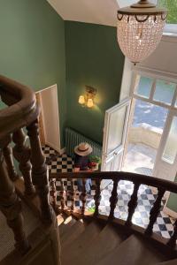 a hallway with a staircase with a glass door at La Maison 1680 in Couches