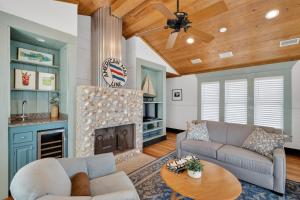 a living room with a couch and a fireplace at Emil Cottage in Saint Simons Island