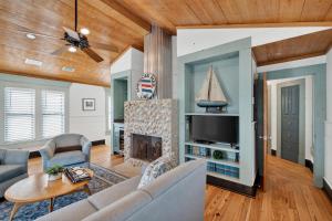 a living room with a couch and a fireplace at Emil Cottage in Saint Simons Island