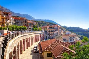an old stone bridge over a city with buildings at Arachova Boka's House, Elegant Apartment in Arachova