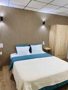 a bedroom with a large bed in a room at BEACH Arguineguin FIRST LINE CHG FAMILY HOTEL in Arguineguín