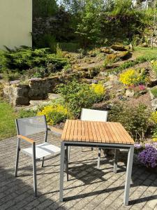 a table and two chairs sitting next to a garden at Ferienhaus am Schloss in Tittling