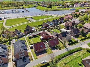 an aerial view of a village with houses and a river at Nordseeperle in Greetsiel