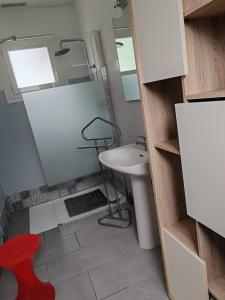 a bathroom with a sink and a mirror and a stool at Espadrille Océan in Léon +20 photos