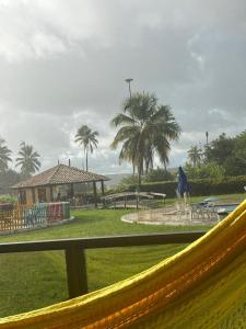 a view of a park with palm trees and a playground at GAVOA Beach FLAT in Água Boa +2 photos