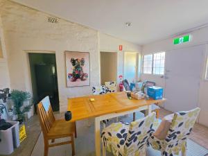 a dining room with a wooden table and chairs at Eden - Franklin 6 in Adelaide