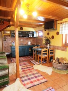 a living room with a kitchen and a dining room at Chata pod Lazíkom in Liptovský Hrádok