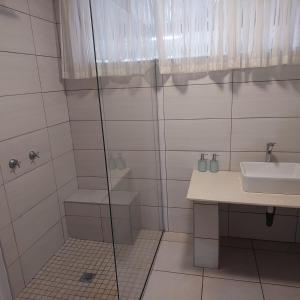 a bathroom with a shower and a sink at 1atKruger Unit 2 in Mokopane