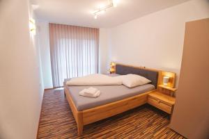 a bedroom with a bed with a wooden head board at EK-Living in Fügen