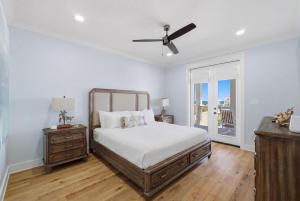 a bedroom with a bed and a ceiling fan at The Perch in Gulf Shores +77 photos