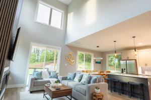 a living room with a couch and a table at Cliffside Modern Villa. Secluded and accessible. in Asheville