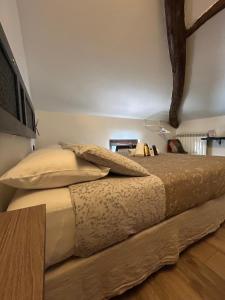 a bedroom with a large bed with two shoes on it at Poste Regie - Milan Guest House in Milan