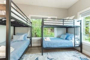 two bunk beds in a room with a window at Cliffside Modern Villa. Secluded and accessible. in Asheville +81 photos