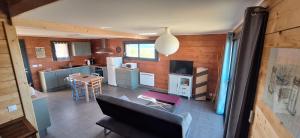 a room with a kitchen and a living room at La Maison En Bois in Figeac