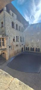 a large brick building with a large courtyard at La Maison En Bois in Figeac