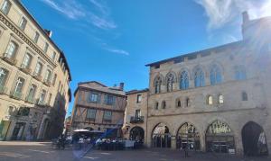 a group of buildings on a city street at La Maison En Bois in Figeac