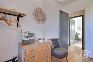 a room with a dresser and a chair and a mirror at Maison d'hôtes de kervor in Plouézec