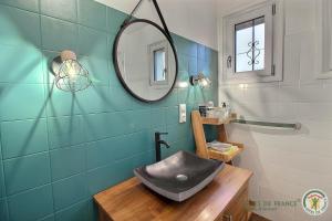 a bathroom with a sink and a mirror at Maison d'hôtes de kervor in Plouézec +12 photos