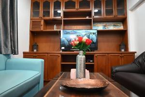 a vase with flowers on a table in a living room at Patong Beach private Villa in Patong Beach