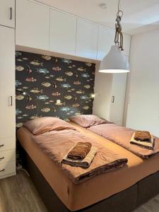 a bedroom with two beds with a headboard with a pattern at Mariehus in Wangerooge