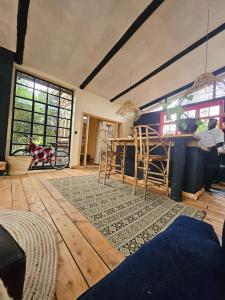a living room with a table and chairs in it at TheCabinsNanyuki in Nanyuki