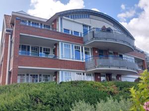 a large brick building with a round balcony at de Bark in Dorum-Neufeld
