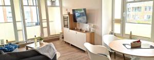 a living room with a couch and a table at de Bark in Dorum-Neufeld