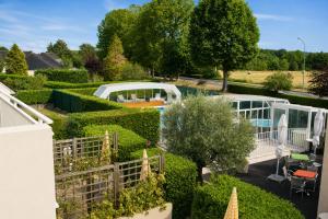an aerial view of a garden with hedges and a house at Logis Hotel Restaurant L'Escapade in Le Pêchereau
