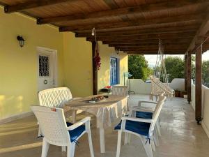 a dining table and chairs on a patio at Casa de Palma in Asprovalta