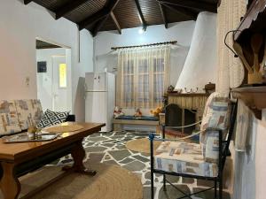 a living room with a table and a fireplace at Casa de Palma in Asprovalta +16 photos