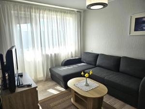 a living room with a couch and a table at Side Korterid in Rakvere