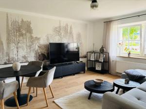 a living room with a flat screen tv at Fewo Seestern in Neukieritzsch