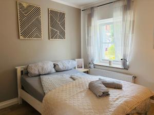 a bed with two pillows on it in a bedroom at Fewo Seestern in Neukieritzsch
