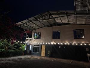 a building with lights on the side of it at night at Hotel Don Roberto in San Isidro de El General