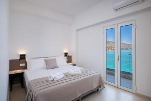 a bedroom with a bed with a view of the ocean at Blue Horizon Elounda in Elounda