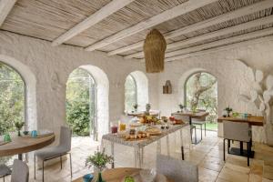 a dining room with a table with food on it at Puntebianche Resort in Ceglie Messapica