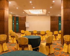 a conference room with a round table and chairs at Royal Crown Muscat in Muscat
