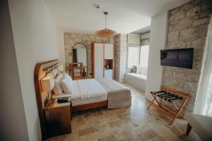a bedroom with a bed and a tv in a room at Alaçatı Lotus Bahçe in Alaçatı