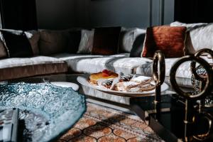 a living room with a table with a plate of food at Summer Villa in Lahore