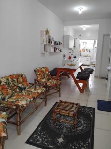 a living room with two couches and a table at EM CASA in Palhoça