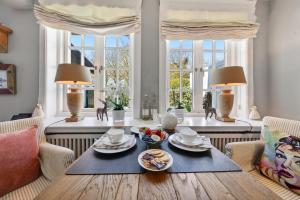 a dining room with a table with food on it at Stutenhof-EG-Wohnung-3 in Keitum